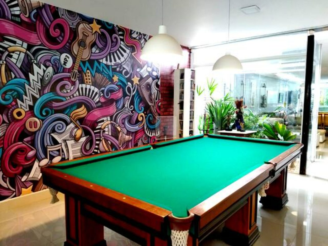 Sala de sinuca com mural grafitado